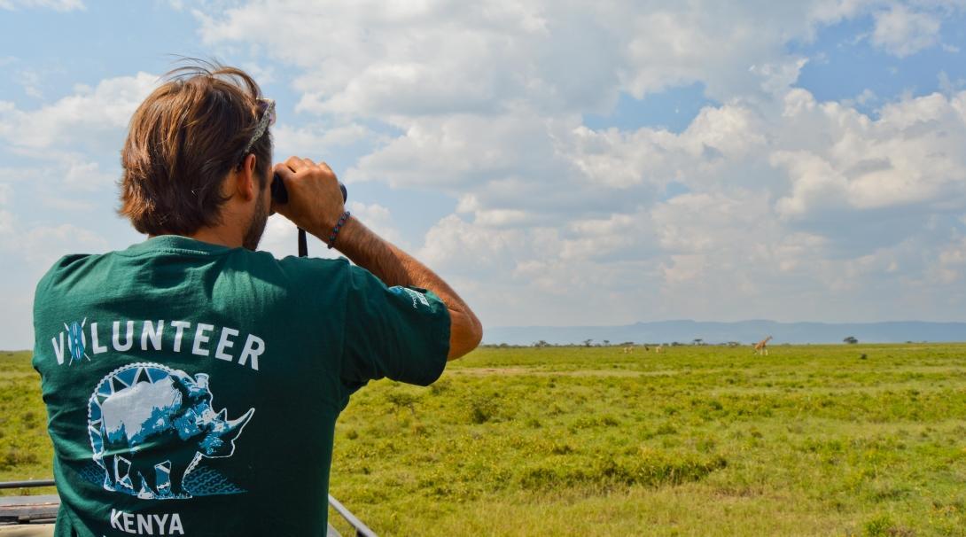 In Kenya we offer a Conservation project where volunteers help with monitoring wildlife. A Projects Abroad volunteer in Kenya is looking at wildlife through his binoculars.